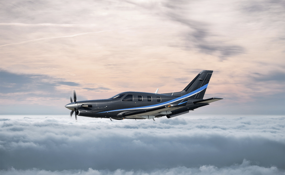 Daher TBM 960 Turboprop-Flugzeug im Flug Daher TBM 960 Turboprop-Flugzeug im Flug über einer Wolkendecke bei Sonnenuntergang.