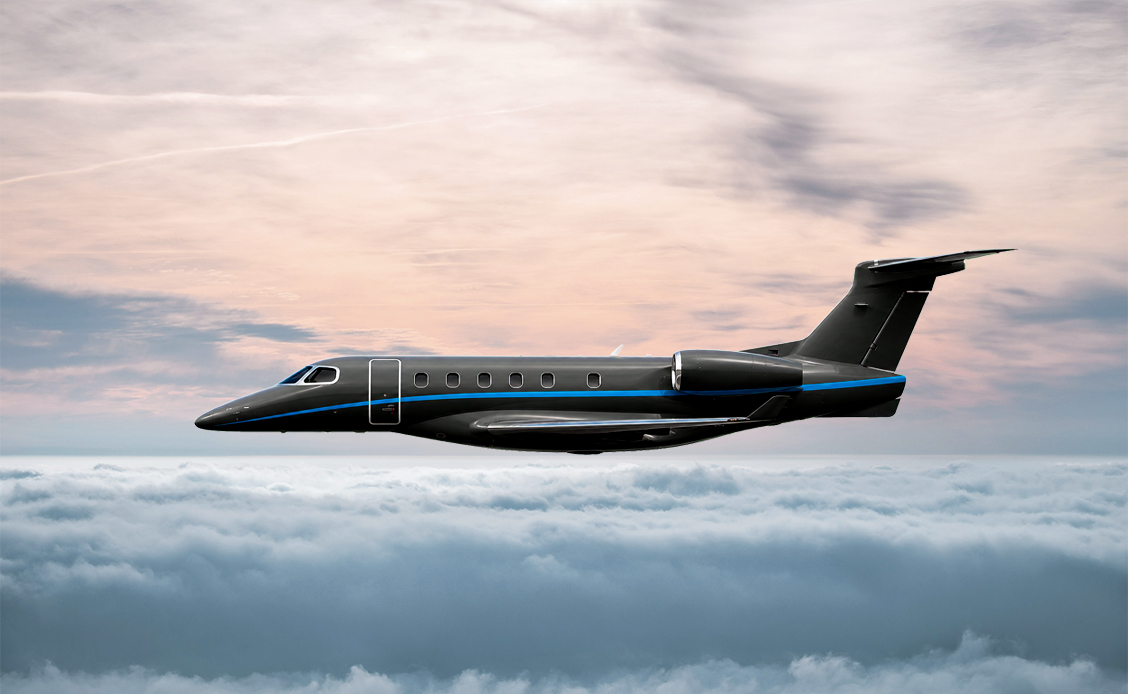 Embraer Phenom 300E Light Jet im Flug Embraer Phenom 300E Light Jet im Flug über einer Wolkendecke bei Sonnenuntergang.